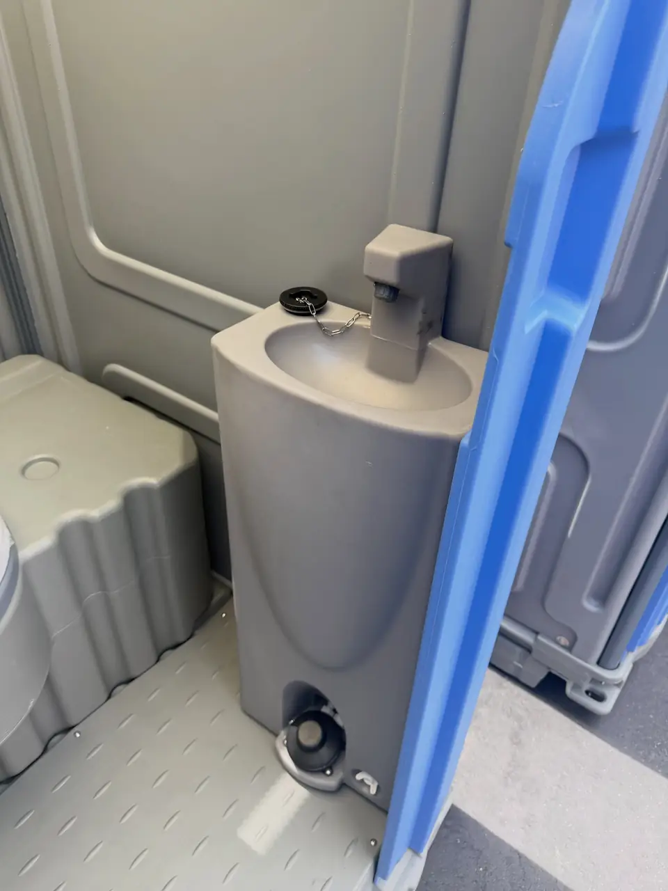 Grey portable hand washing sink with a foot pump