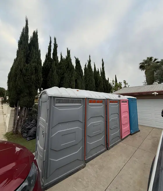 Row of portable restrooms with a wide accessible unit