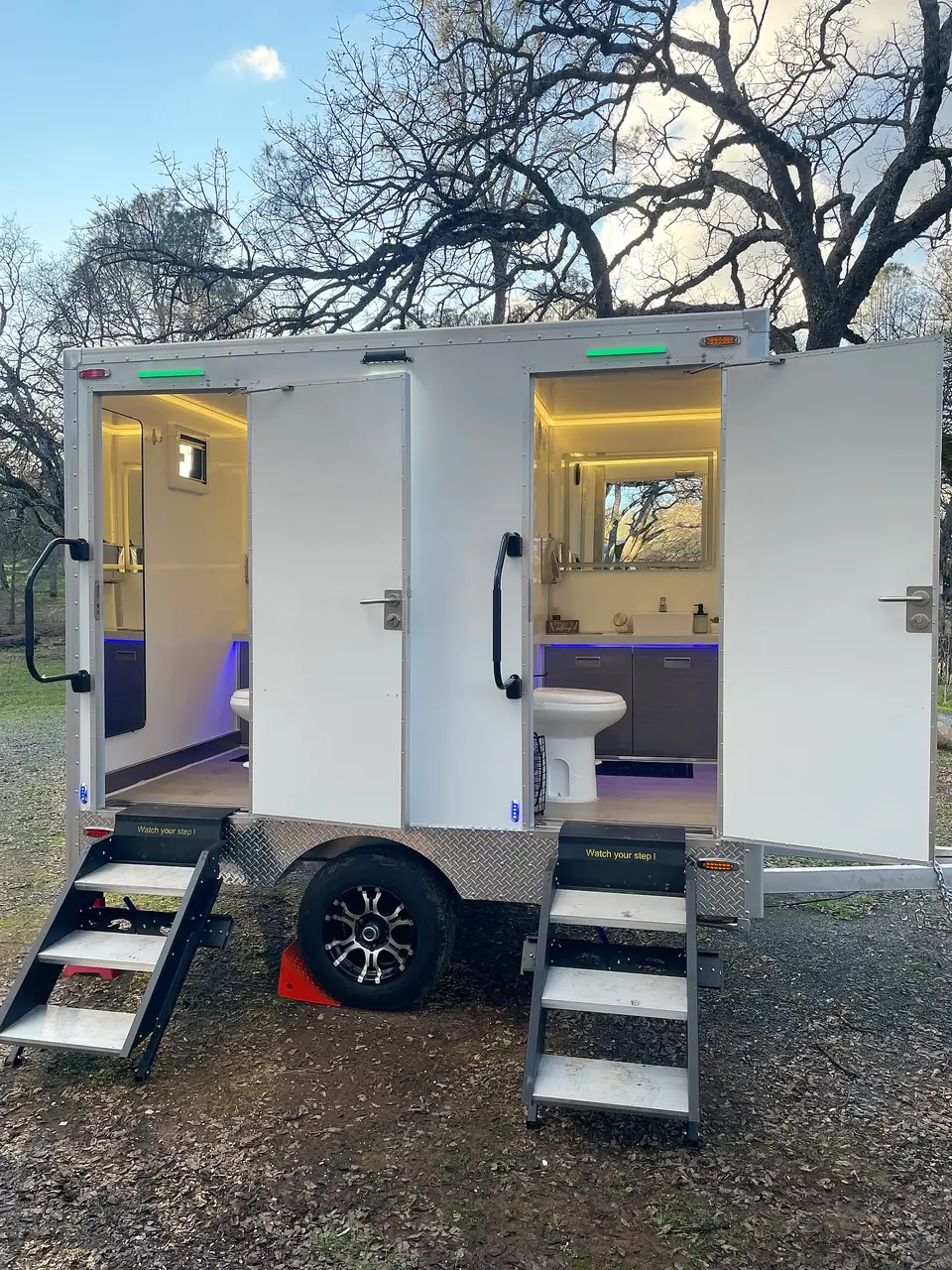 Two-stall restroom trailer with lit interior