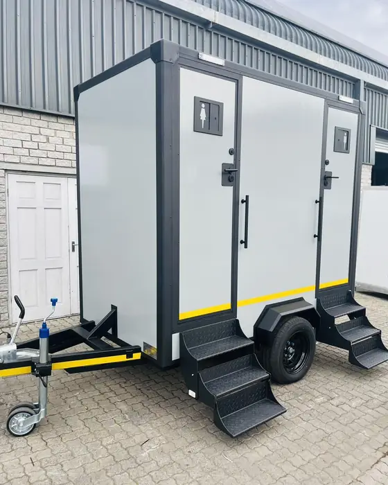 White two-stall restroom trailer