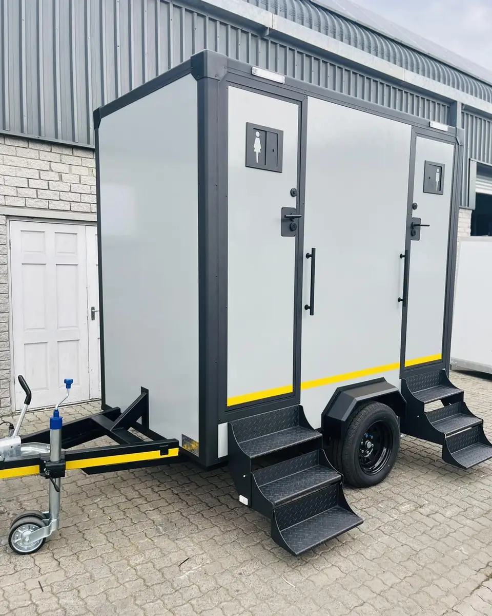 White two-stall restroom trailer
